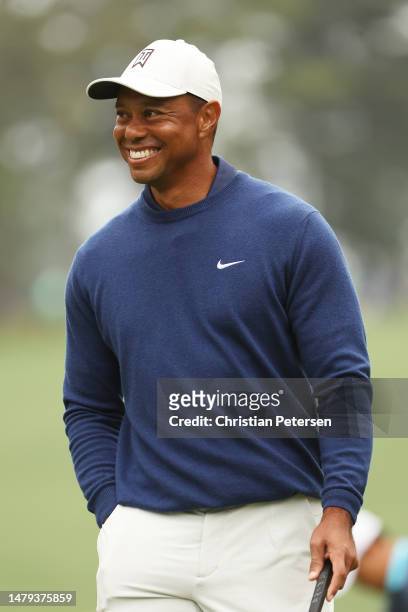Tiger Woods of the United States laughs on the tenth green during a practice round prior to the 2023 Masters Tournament at Augusta National Golf Club...