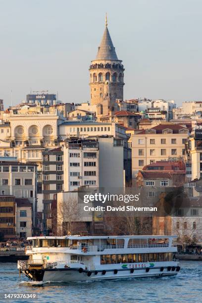 Passenger ferry depart the Kadıköy and Üsküdar pier in the Golden Horn waterway for Eminönü, with the Galata Tower in the background, on March 20,...