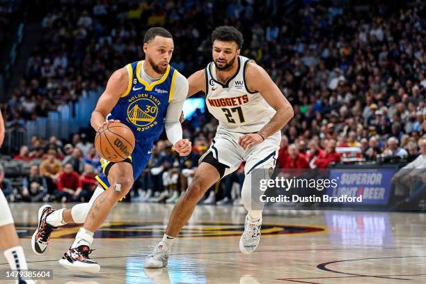 Stephen Curry of the Golden State Warriors dribbles against Jamal Murray of the Denver Nuggets in the second half of a game at Ball Arena on April 2,...