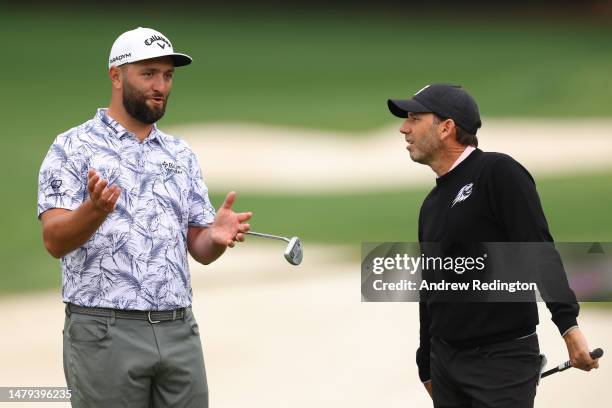 Jon Rahm of Spain talks with Sergio Garcia of during a practice round prior to the 2023 Masters Tournament at Augusta National Golf Club on April 03,...