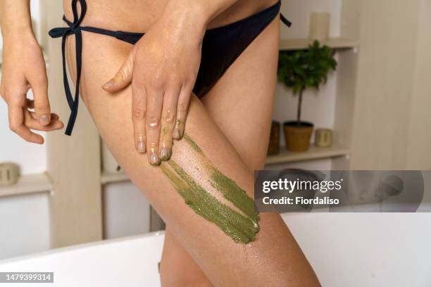 body cream or anti-cellulite scrub, smear of gel on female leg - people covered in mud stock pictures, royalty-free photos & images