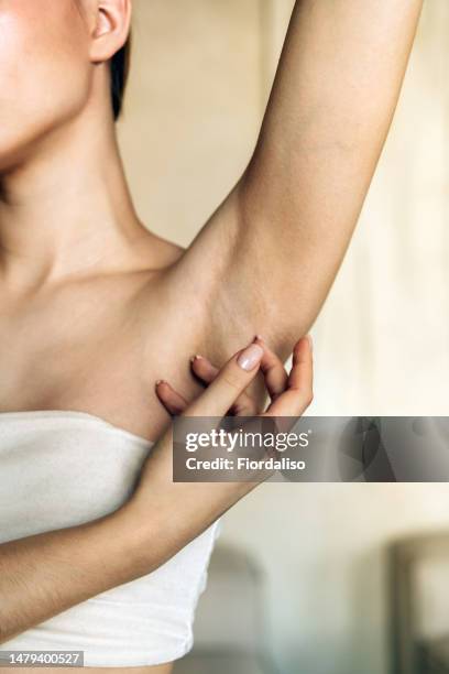 woman holding bottle of spray, thermal water, moisturizing liquid, hydrolat, body lotion - underarm stock pictures, royalty-free photos & images