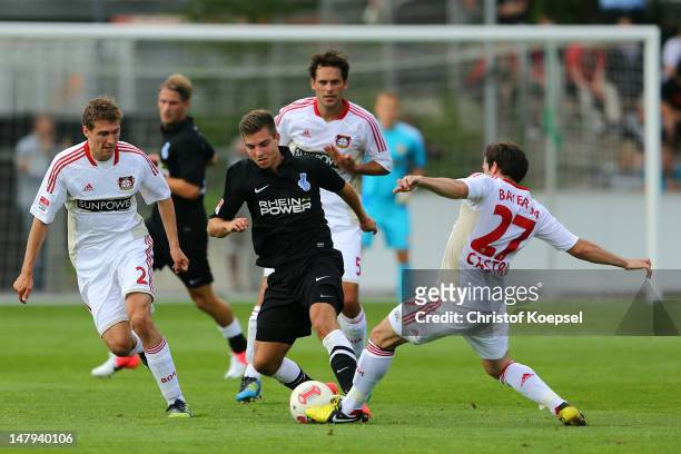Daniel Schwaab of Leverkusen and Gonzalo Castro challenges Kevin WOlze of Duisburg during the friendly match between Bayer Leverkusen and MSV...