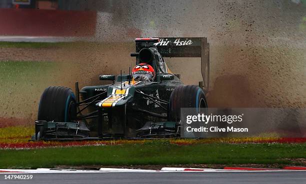 Heikki Kovalainen of Finland and Caterham slids off the track in the wet during practice for the British Grand Prix at Silverstone Circuit on July 6,...