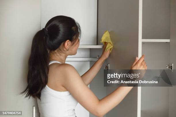 young asian woman cleaning home - clean closet stock pictures, royalty-free photos & images