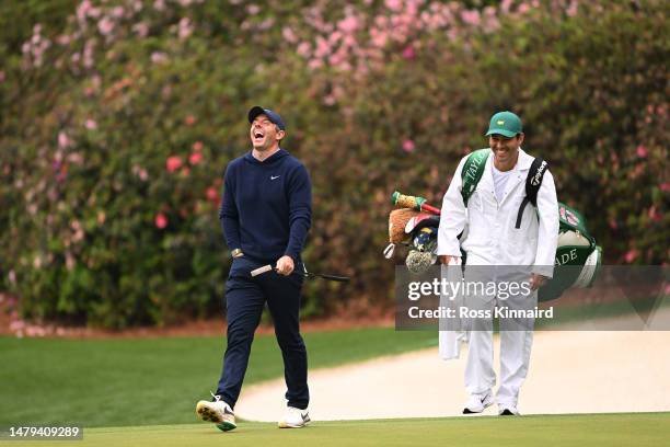 Rory McIlroy of Northern Ireland and caddie Harry Diamond walk on the 13th green during a practice round prior to the 2023 Masters Tournament at...
