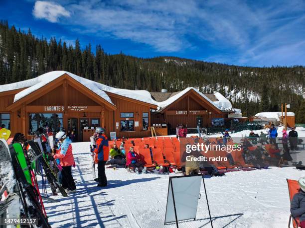 people resting in the sunshine from skiing at labonte's on mountain ski lodge, keystone, colorado - keystone stock pictures, royalty-free photos & images