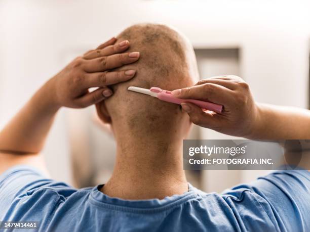 young taiwanese lgbtq woman with alopecia shaving her head - shaving head stock pictures, royalty-free photos & images