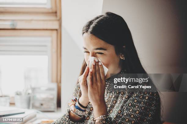 close up student writing - closeup of a hispanic woman sneezing foto e immagini stock