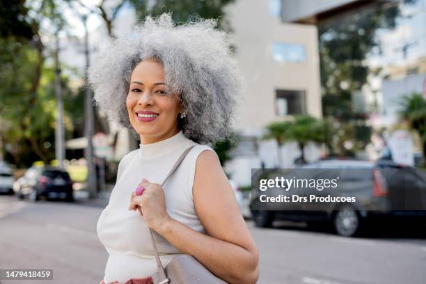 portrait of mature businesswoman in the city - black purse stock pictures, royalty-free photos & images