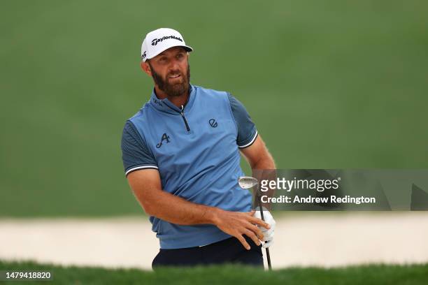 Dustin Johnson of the United States plays a shot from a bunker on the tenth hole during a practice round prior to the 2023 Masters Tournament at...