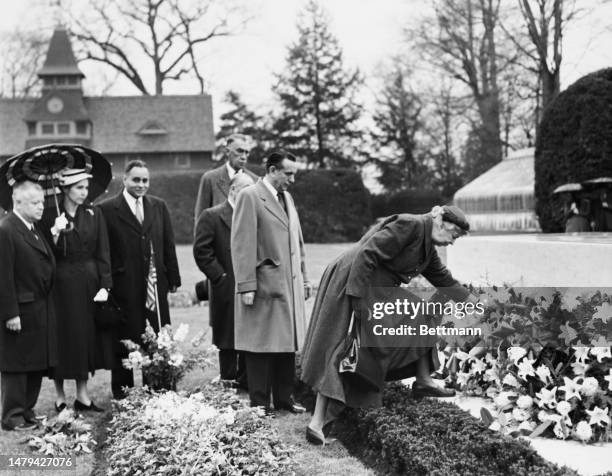 Eleanor Roosevelt places a wreath at her husband's grave during a memorial ceremony in Hyde Park, New York, on April 12th, 1953. Also in attendance...