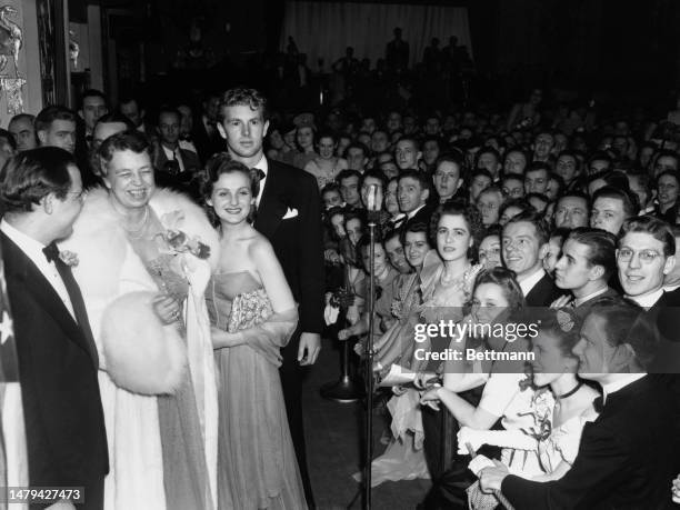 First Lady Eleanor Roosevelt attending a President's Birthday Ball in Washington with bandleader Benny Goodman , singer Constance Moore and actor...