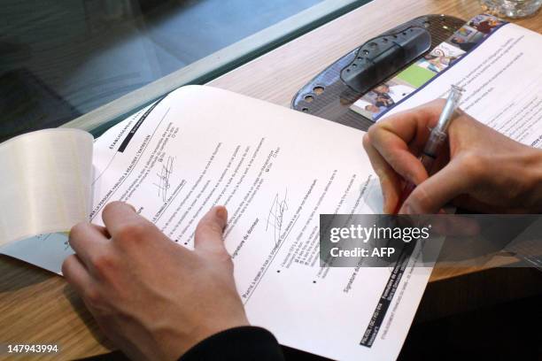 Patient signs a blood donor form prior to give his blood on July 6, 2012 at the blood collection center of the French Institution for Blood in Paris....