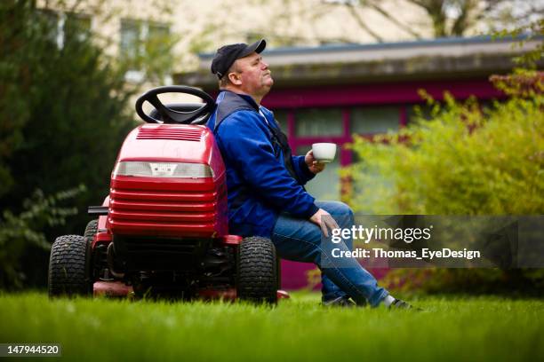 german landscaper taking a coffee break. - lawn tractor stock pictures, royalty-free photos & images