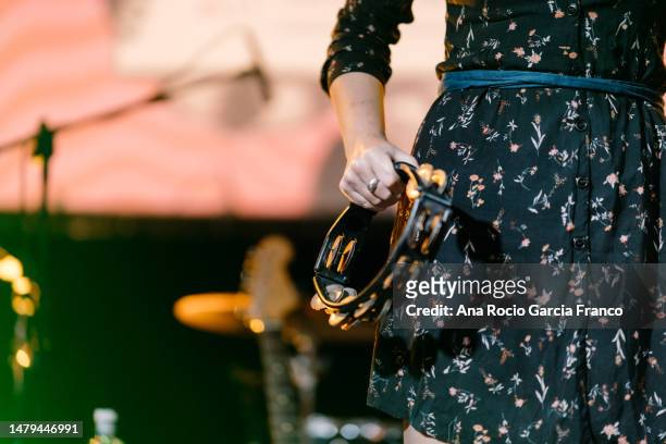 a woman playing the tambourine in a concert - tambourine stock pictures, royalty-free photos & images