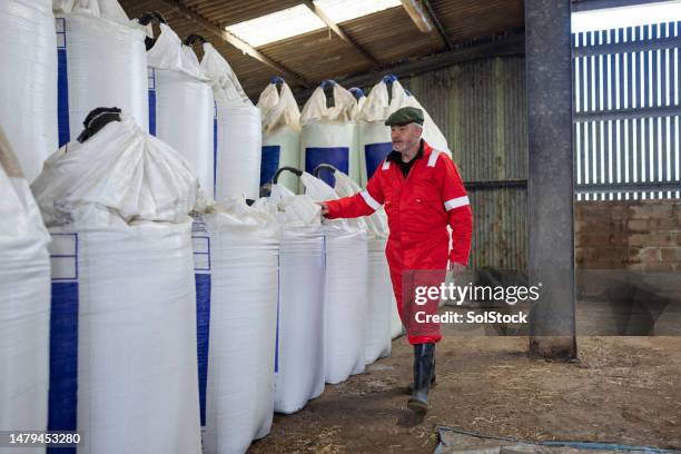 farmer checking on the fertiliser delivery - sack stock pictures, royalty-free photos & images