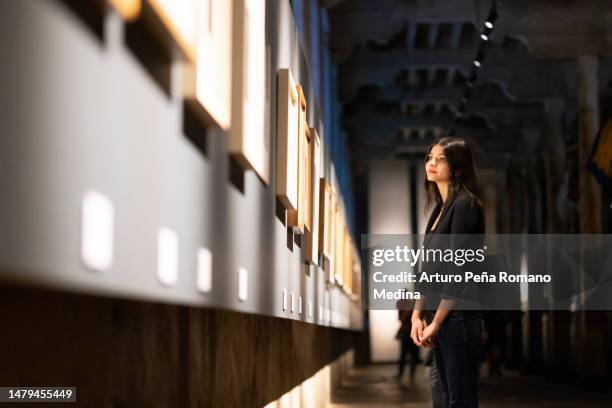 young woman in art gallery - museum of human rights stock pictures, royalty-free photos & images