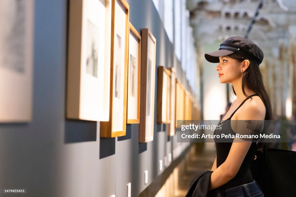 Mujer joven apreciando obras de arte