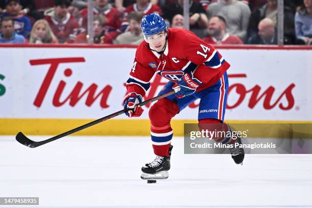 Nick Suzuki of the Montreal Canadiens skates the puck during the second period against the Carolina Hurricanes at Centre Bell on April 1, 2023 in...