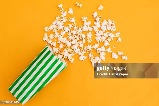 pop corn in yellow background.top down image - popcorn stock pictures, royalty-free photos & images