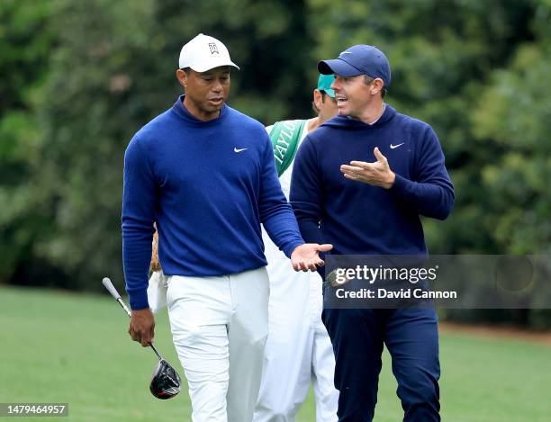 Rory McIlroy of Northern Ireland and Tiger Woods of The United States walk together on the 11th hole during a practice round prior to the 2023...