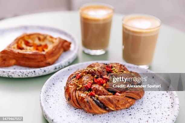 fresh pastry with coffee at a cafe - danish pastry stock pictures, royalty-free photos & images