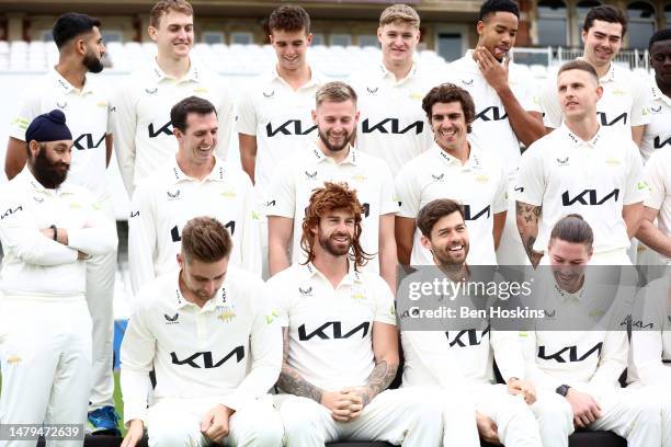 Jordan Clark of Surrey wears a wig for the team picture during the Surrey CCC Photocall at The Kia Oval on April 03, 2023 in London, England.