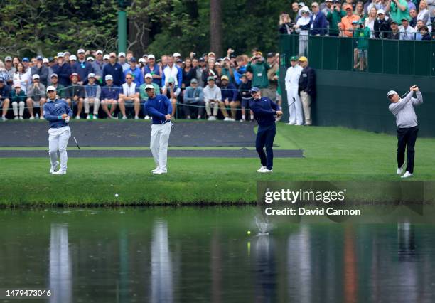 Tom Kim of South Korea , Tiger Woods of The United States , Rory McIlroy of Northern Ireland and Fred Couples of The United States all try to 'skip'...