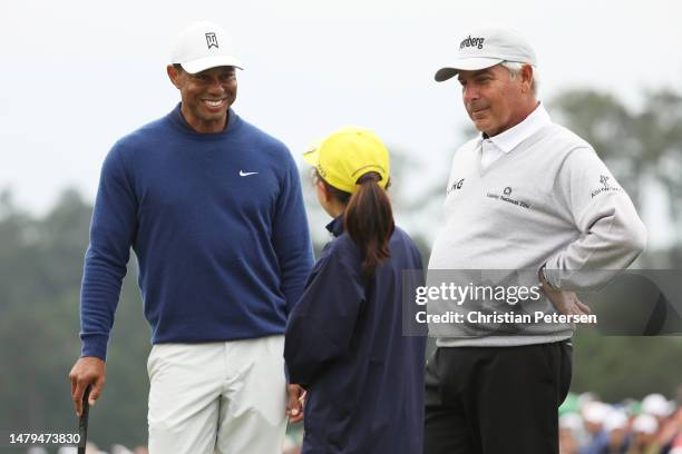 Tiger Woods of the United States and Fred Couples of the United States talk with Ashley Kim, winner of the 7-9 Drive, Chip and Putt Championship...