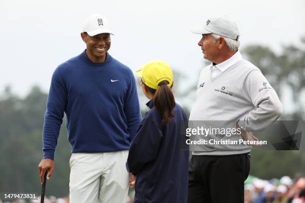 Tiger Woods of the United States and Fred Couples of the United States talk with Ashley Kim, winner of the 7-9 Drive, Chip and Putt Championship...