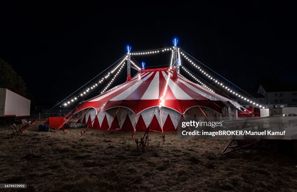 Small red illuminated circus tent at night, Rutesheim, Germany