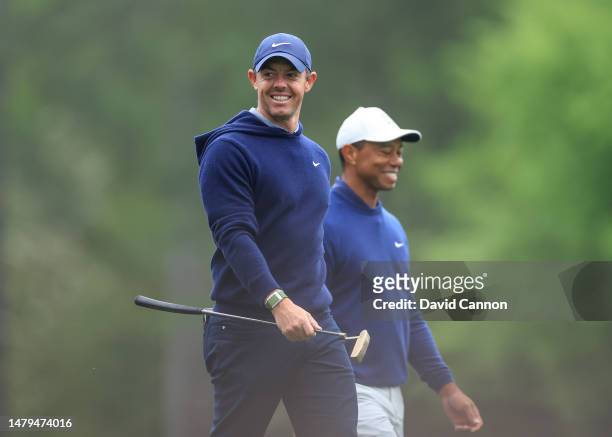 Rory McIlroy of Northern Ireland and Tiger Woods of The United States walk together off the tee on the 12th hole during a practice round prior to the...