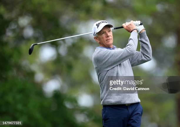 Larry Mize of The United States plays his tee shot on the fourth hole during a practice round prior to the 2023 Masters Tournament at Augusta...