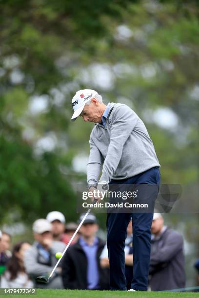 Larry Mize of The United States plays his tee shot on the fourth hole during a practice round prior to the 2023 Masters Tournament at Augusta...