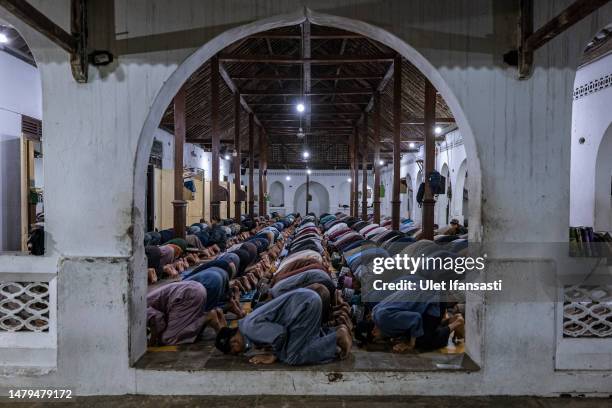 Students perform prayers at the islamic boarding school Al-Fatah Temboro during the holy month of Ramadan on April 03, 2023 in Magetan, East Java,...