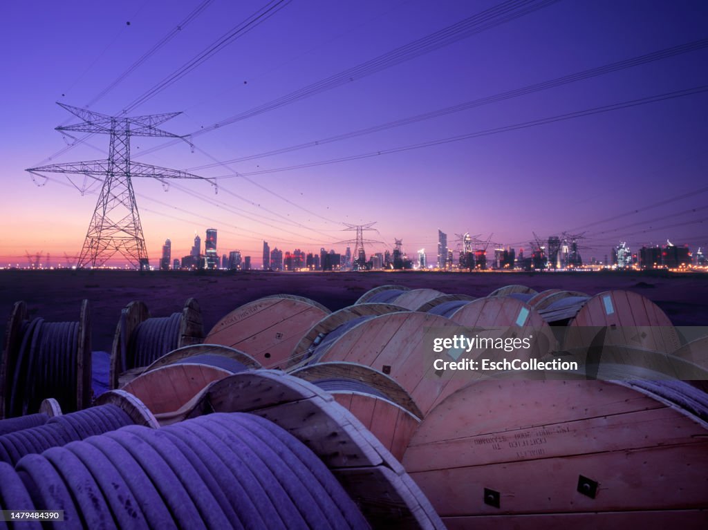 Cable drums and power lines, feeding electricity to the city of Dubai, UAE