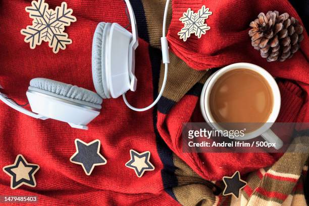 christmas concept cup of coffee and white headphone on red sweater background over light,romania - christmas music fotografías e imágenes de stock
