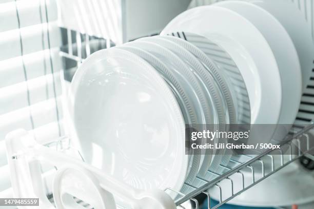 clean dish on a dish rack,romania - washing up stock pictures, royalty-free photos & images