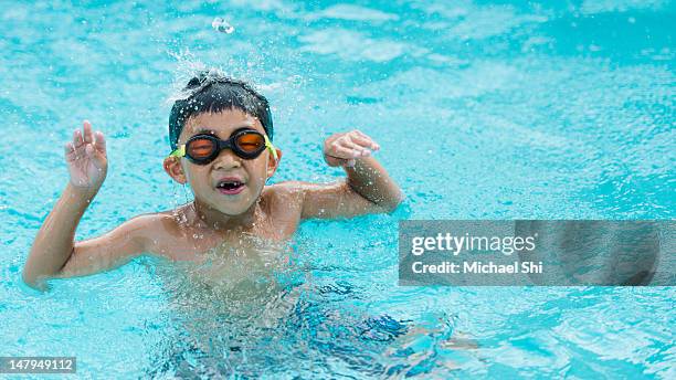 boy cheering in swimming pool - chinese people swimming stock pictures, royalty-free photos & images