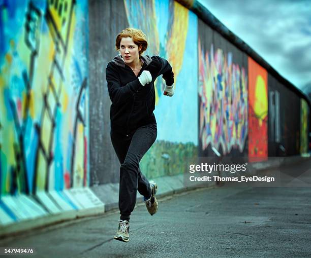woman sprinting the last 100 meters - graffiti hintergrund stock pictures, royalty-free photos & images