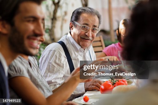 Proud Italian Grandfather having lunch with family Proud Italian Grandfather having lunch with family