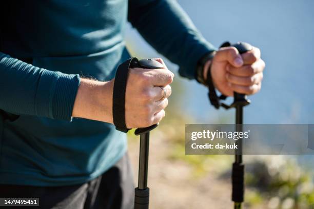 hiking outdoors. hands holding hiking poles close-up - hiking pole stock pictures, royalty-free photos & images