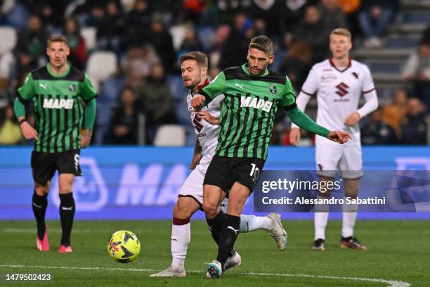 Domenico Berardi of US Sassuolo is challenged by Karol Linetty of Torino FC during the Serie A match between US Sassuolo and Torino FC at Mapei...