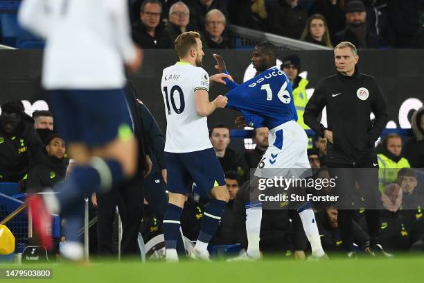 Harry Kane of Tottenham Hotspur and Abdoulaye Doucoure of Everton clash during the Premier League match between Everton FC and Tottenham Hotspur at...