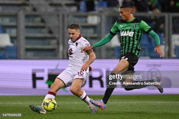 Nikola Vlasic of Torino FC is challenged by Ruan Tressoldi of US Sassuolo during the Serie A match between US Sassuolo and Torino FC at Mapei Stadium...