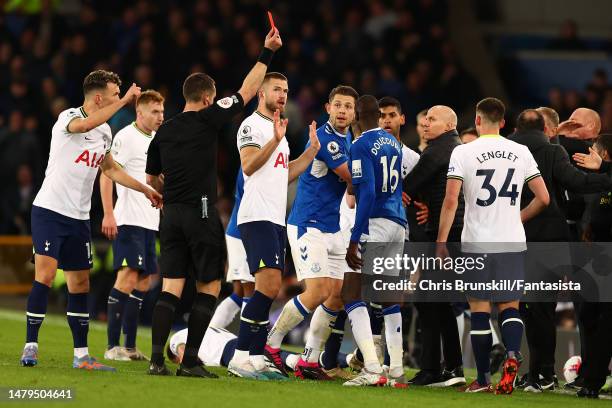 Abdoulaye Doucoure of Everton is shown the red card by referee David Coote during the Premier League match between Everton FC and Tottenham Hotspur...