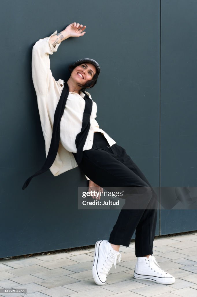 Bohemianlooking Woman In A Peaked Cap Poses With A Strange Gesture High-Res  Stock Photo - Getty Images