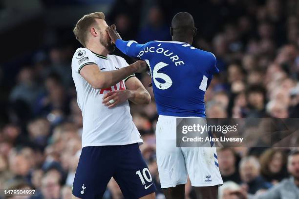 Harry Kane of Tottenham Hotspur and Abdoulaye Doucoure of Everton clash during the Premier League match between Everton FC and Tottenham Hotspur at...