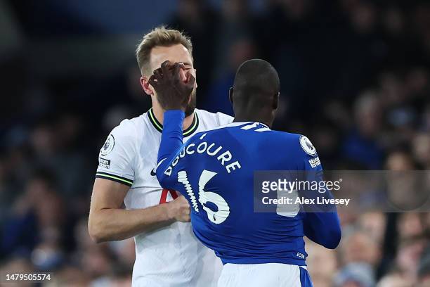 Harry Kane of Tottenham Hotspur and Abdoulaye Doucoure of Everton clash during the Premier League match between Everton FC and Tottenham Hotspur at...